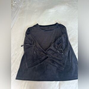 Adorable velour top with ribbon ties and bell sleeves.  Dress it up or down.